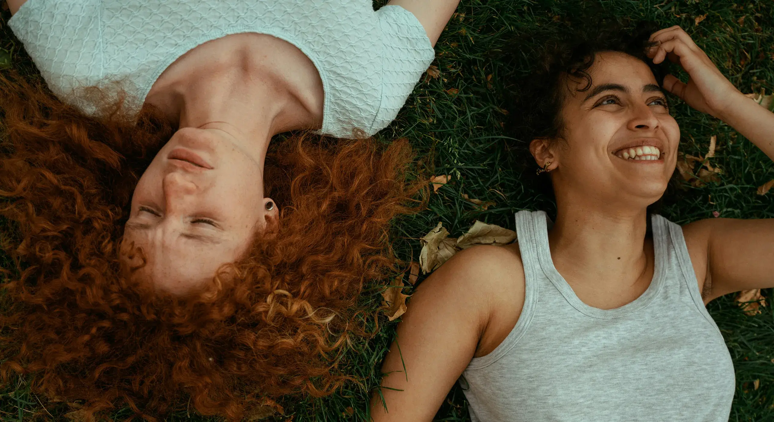 Here for Our Community Two young people laying in the grass