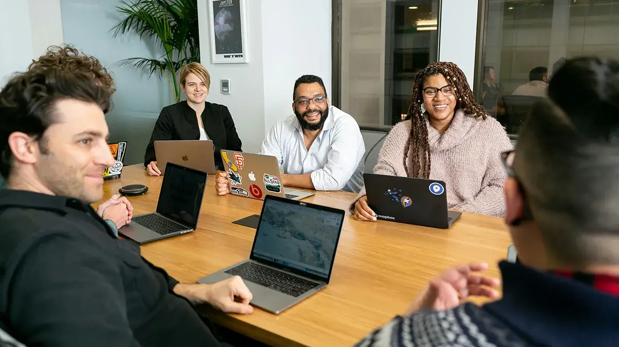 Thank You for Sponsoring Group smiling at conference table