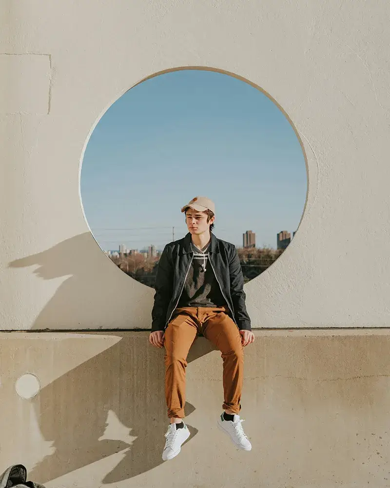 build-a-healthier-future A teen boy sitting on concrete