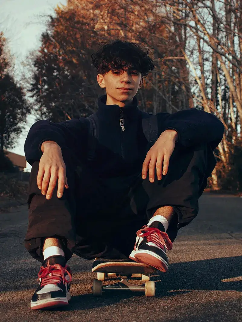 contraceptive-services A teenage boy sitting on a skateboard