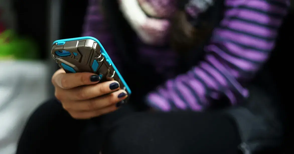 find-a-clinic-healthcare A teen on their phone