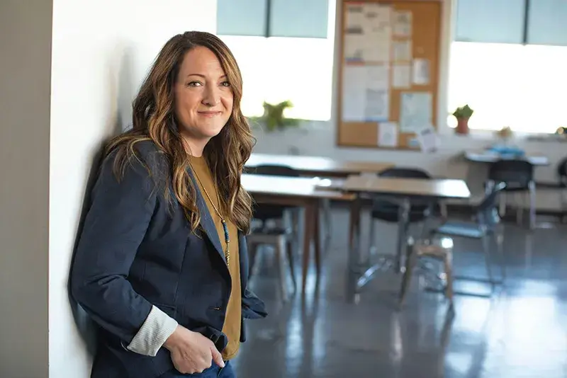 for-professionals-resources A teacher standing in the doorway of her classroom