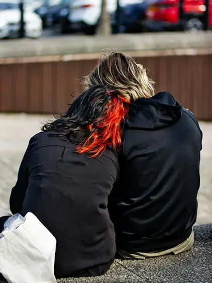 one-love-foundation A person leaning on another's shoulder