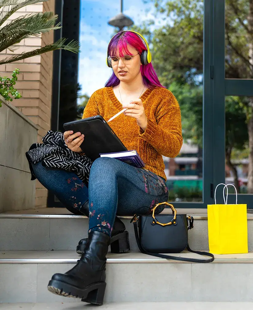 Listening Is Our Superpower Young woman looking at tablet device sitting outside