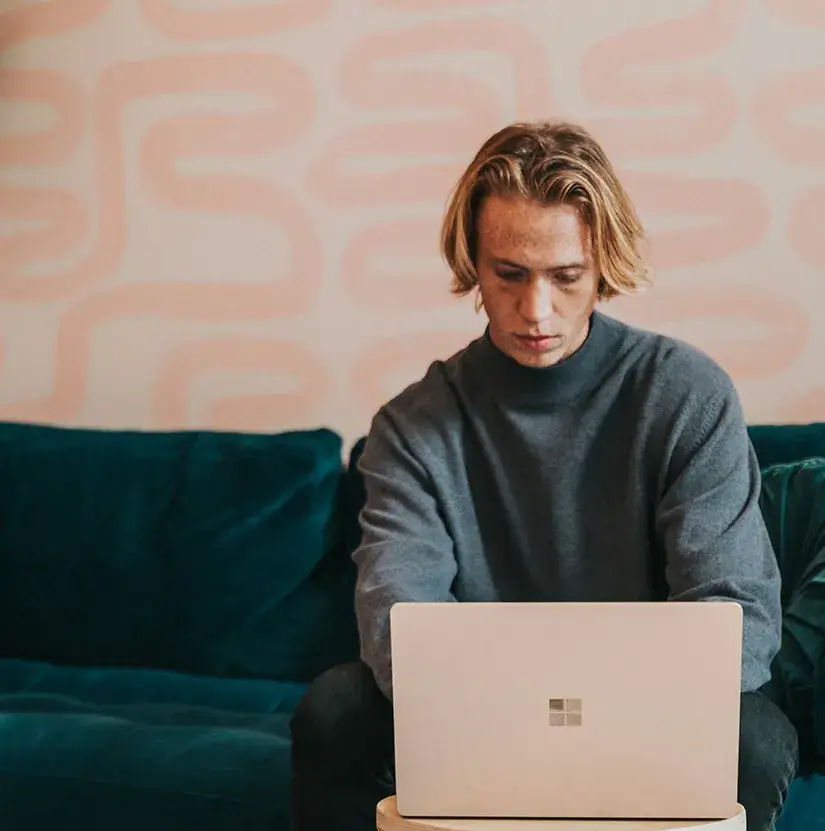 Spark Good With Spare Change Young man typing on laptop