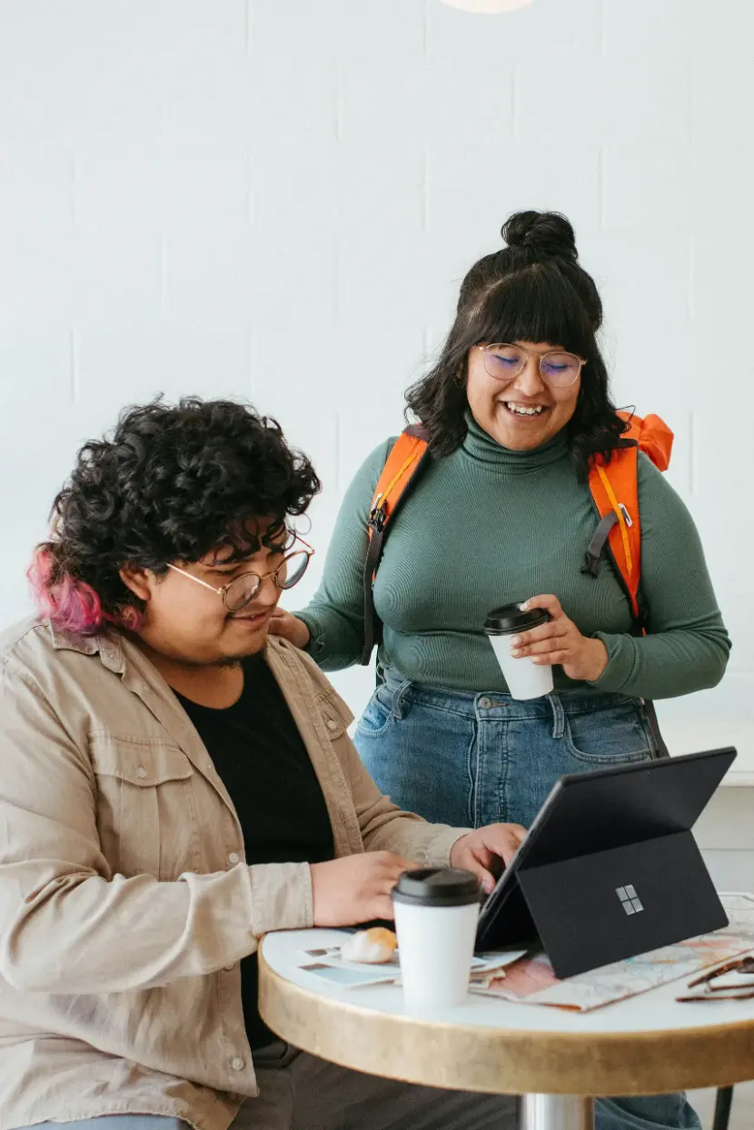 Two people looking at information on a tablet device